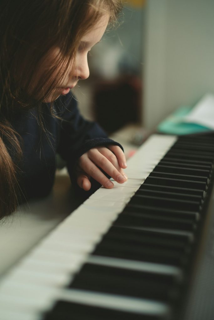 a-young-girl-is-playing-the-piano-with-her-hands-jume8j-ucui